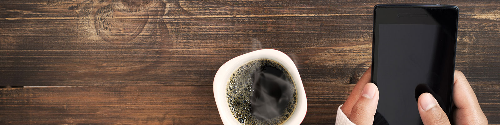 student texting while enjoying coffee