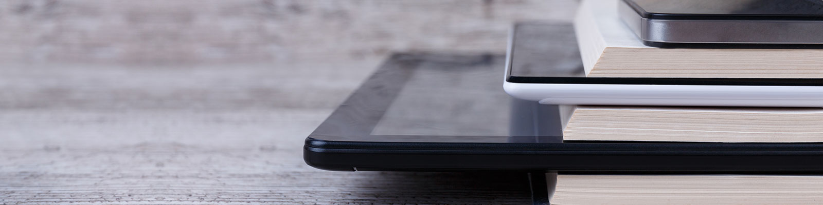 stack of books and mobile devices