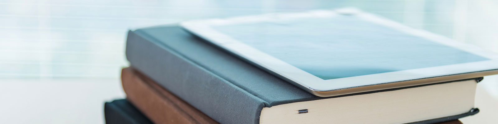 tablet atop stack of books