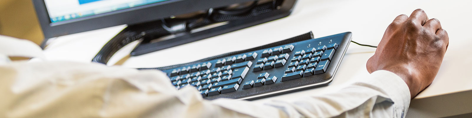 hand on computer mouse at desktop