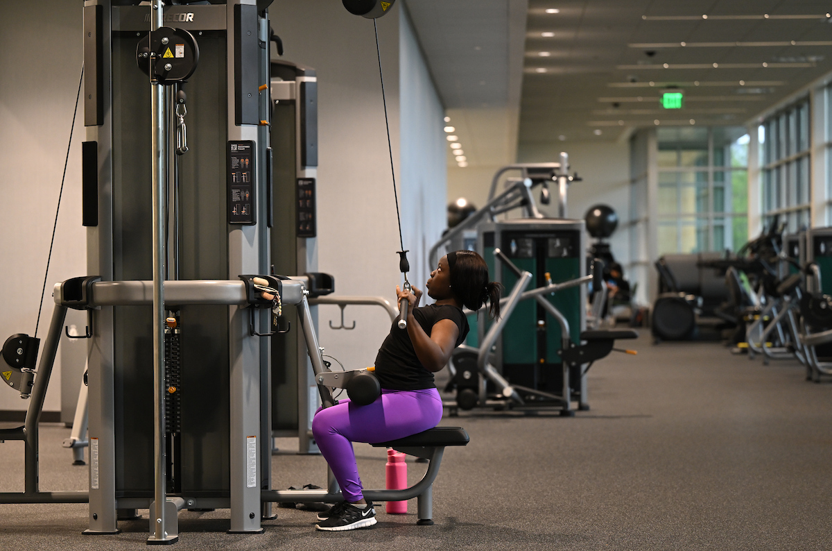 Niecia Say works out on the cable machine in the fitness area at GGC's Convocation Center