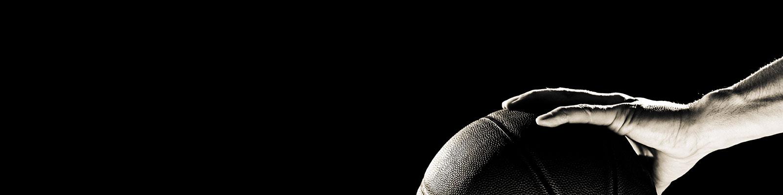 hand holding a basketball, black and white image hand holding a basketball, black and white image