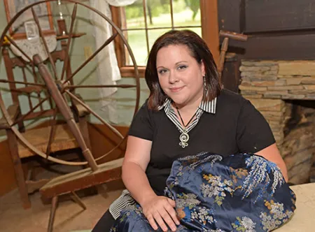 History student with textile at historical site