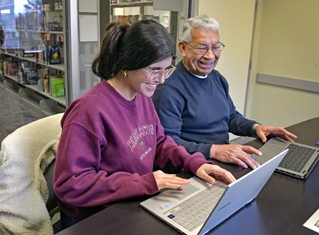 Emily Borrego and Carlos Delgado studying with their laptops