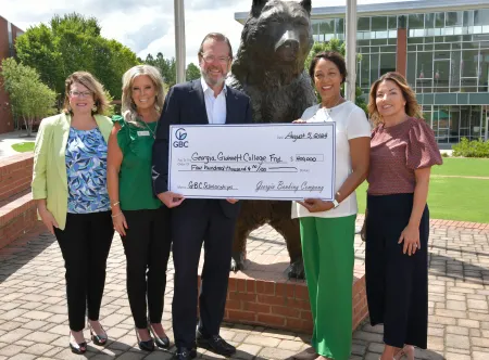 Georgia Banking Company’s CEO, Bartow Morgan Jr., presented a $400,000 check to Georgia Gwinnett College President Jann L. Joseph. This significant donation, aimed at establishing scholarships at the college, was celebrated in the presence of (l-r) Georgia Gwinnett College’s AVP for Advancement, Jennifer Hendrickson, Georgia Banking Company’s Gwinnett Market President, Jennifer Bridwell, Georgia Banking Company CEO Bartow Morgan Jr., and Business Development Officer/Bold Banker, Wanda Weeger.