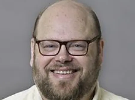 Dr. Eugene Berger smiling at camera