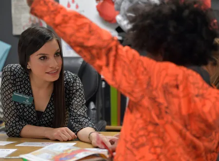 GGC student teacher in the classroom spending one-on-one time with young student