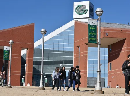 Students walking in front of Building B on campus.