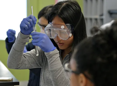 Student looking at a test tube