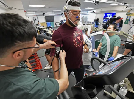 Student taking another student's blood pressure