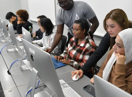 People looking at desktop computers