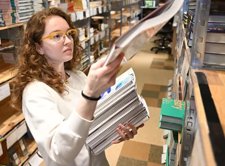 Kayleigh Crews, GGC’s interim store manager, organizes and stacks the new books in preparation for the start of the fall semester.