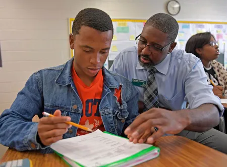 GGC student helping a high school student during and in-class teaching experience