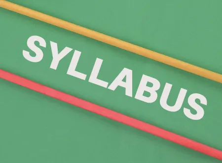 The word syllabus written diagonally on an image with a green background and yellow and red lines
