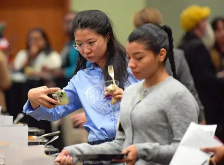 Yingg Guo takes a photo of the Annual Thanksgiving Feast