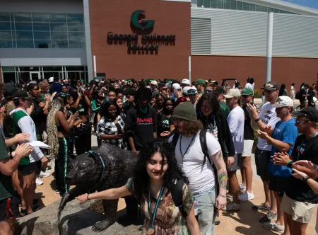 Students rubbing grizzly statue nose at the 2025 First-Year Convocation ceremony