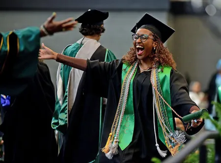 Nursing student Prudence Donald celebrates during the fall commencement