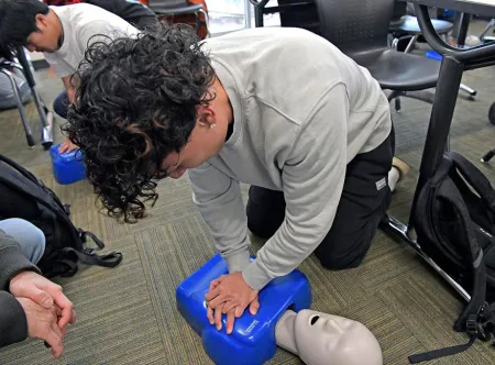 GGC students learning and practicing CPR