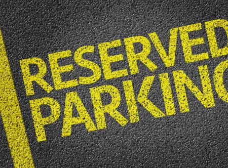 Reserved parking written in yellow on asphalt