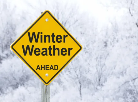 Yellow and black winter weather image with snow filled background