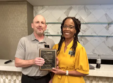 Dr. Alvina Atkinson smiles with an award she received from the American Mathematical Association of Two-Year Colleges.