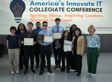 A group of students holding their awards won at the America's Innovate IT Collegiate Conference. 