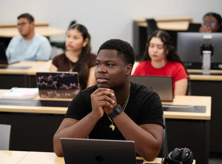 Students listening to a lecture in the Business SIM lab