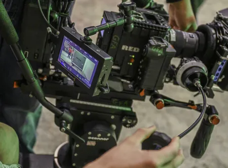 A person looking at the monitor on a RED camera