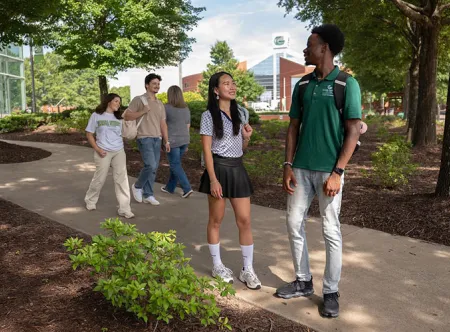 GGC students between classes walking near the library