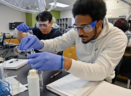 Two students conducting lab experients