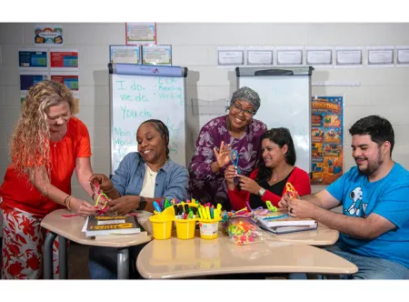 April Ferraro, Nimat Muhammad, Fatoumata Bah, Michelle Saldanha and Will Reyes laugh together as they work on crafts during the Georgia Gwinnett College's School of Education at Discovery High School.