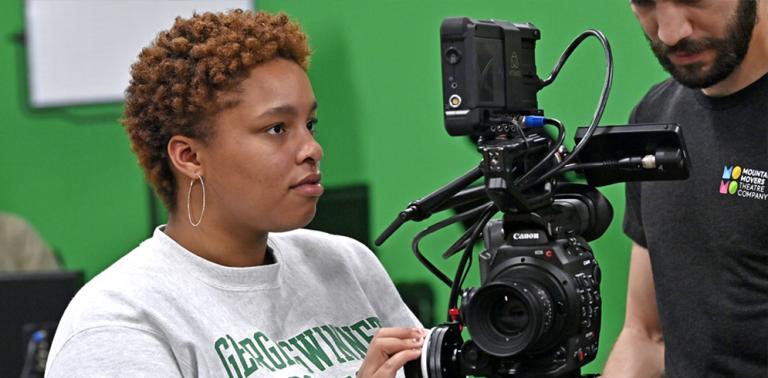 Female student behind the camera