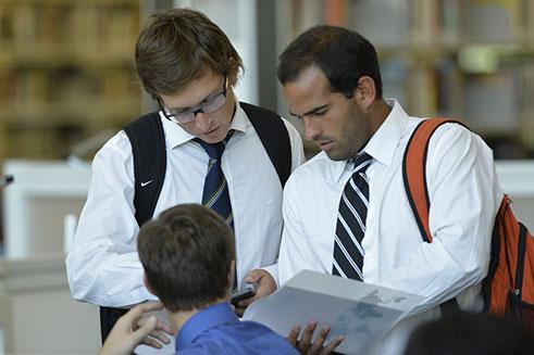 Engaged students collaborating in business attire