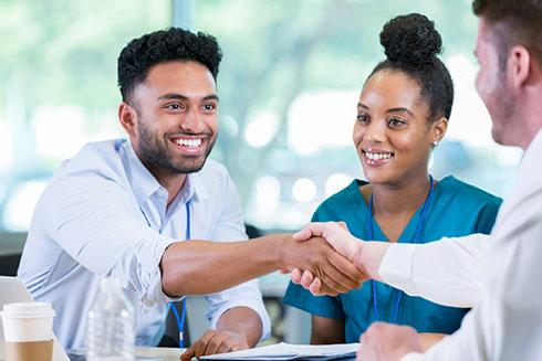 Health care professionals shaking hands