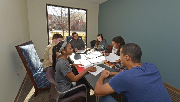 Group of students meeting in housing conference room