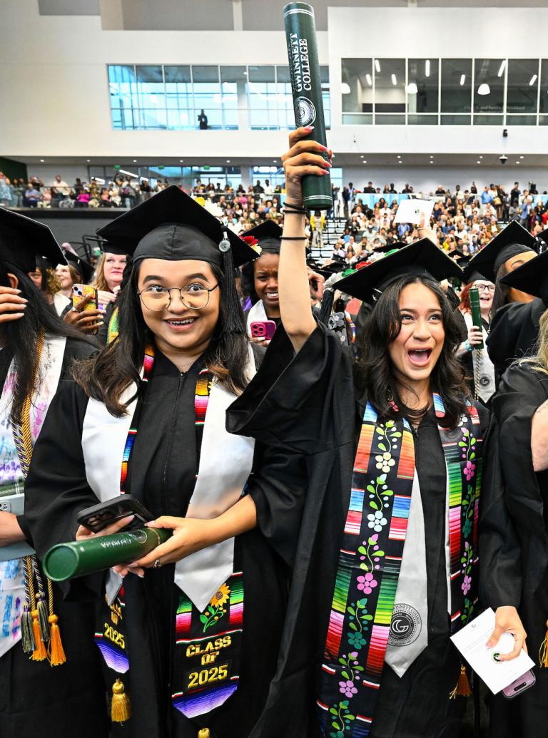 GGC graduates cheering during 2025 Spring Commencement in the Convocation Center