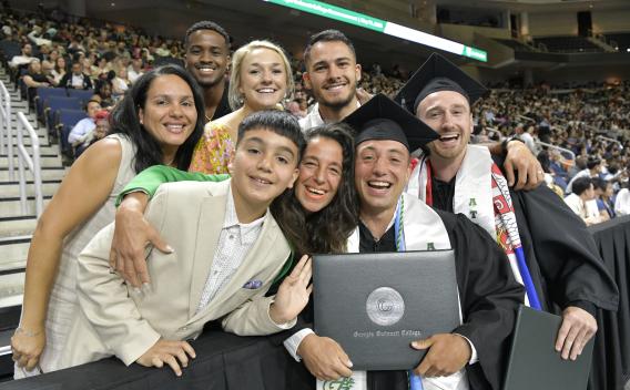 Two GGC graduates celebrating with their families