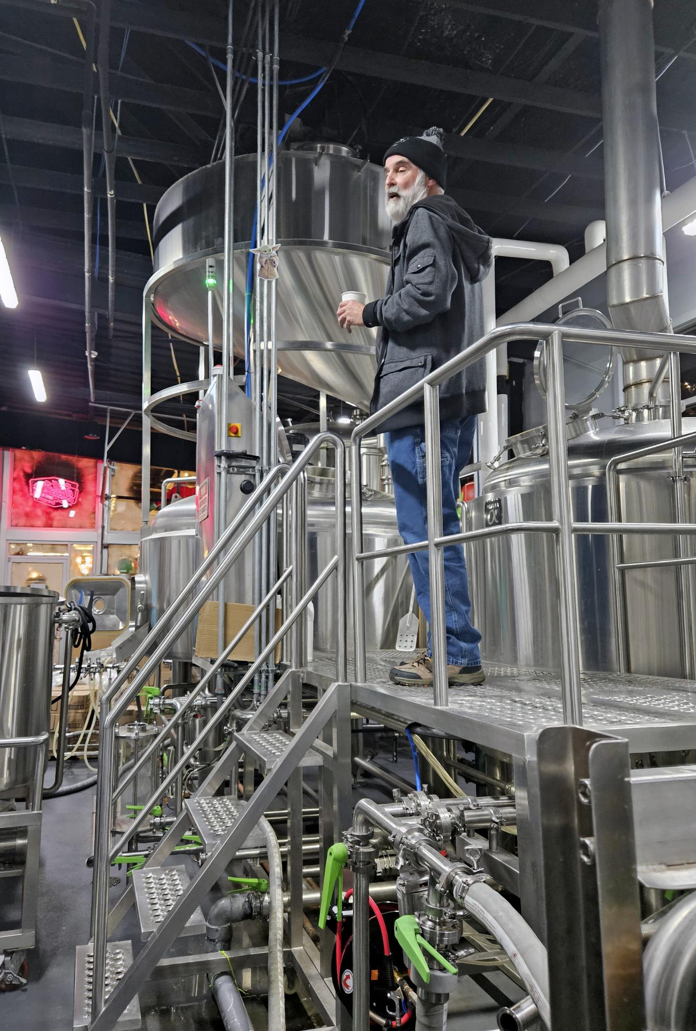StillFire Brewing owner, Phil Farrell on the catwalk between the fermentation vessels.