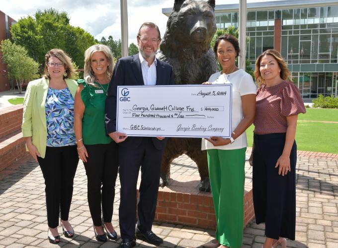 Georgia Banking Company’s CEO, Bartow Morgan Jr., presented a $400,000 check to Georgia Gwinnett College President Jann L. Joseph. This significant donation, aimed at establishing scholarships at the college, was celebrated in the presence of (l-r) Georgia Gwinnett College’s AVP for Advancement, Jennifer Hendrickson, Georgia Banking Company’s Gwinnett Market President, Jennifer Bridwell, Georgia Banking Company CEO Bartow Morgan Jr., and Business Development Officer/Bold Banker, Wanda Weeger.