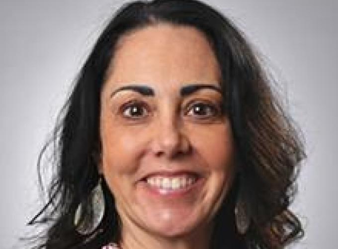 Dr. Rebecca Cooper smiling at camera