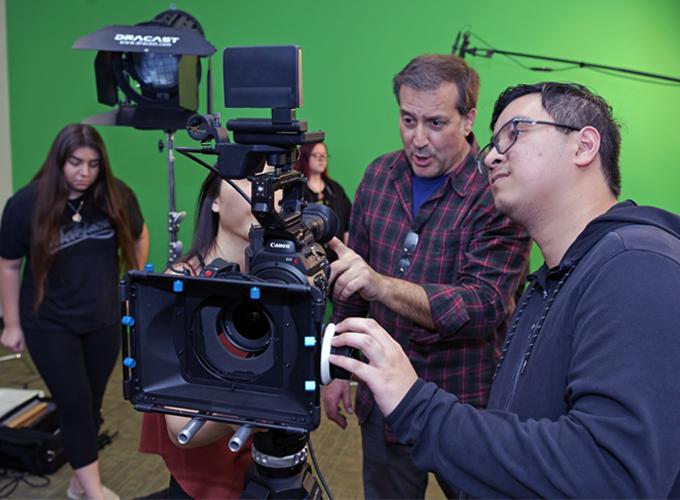 Students looking at film camera