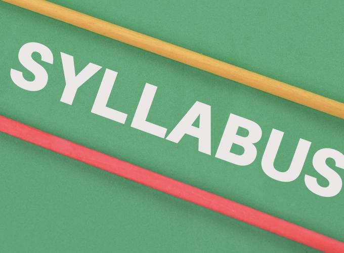 White-lettered word syllabus written on green background with yellow and red stripes