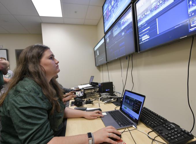 People looking at monitors