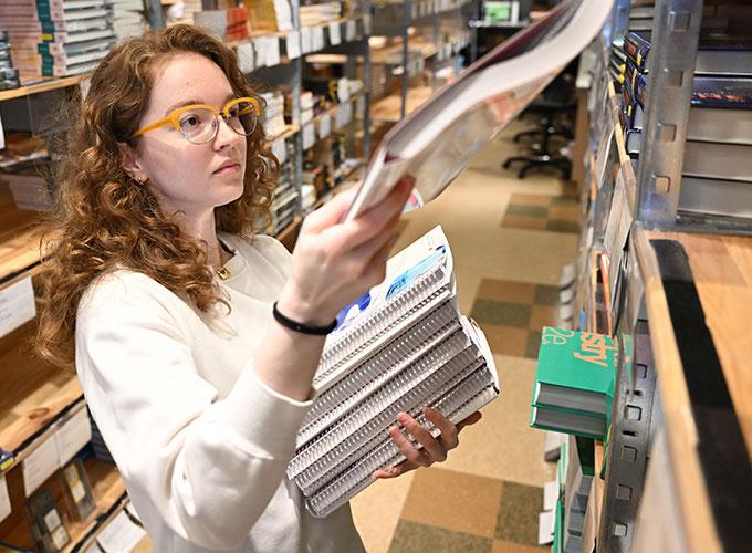 Kayleigh Crews, GGC’s interim store manager, organizes and stacks the new books in preparation for the start of the fall semester.