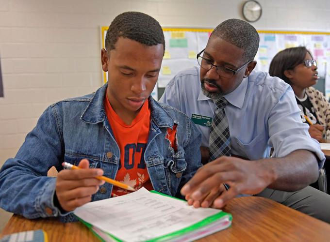 GGC student helping a high school student during and in-class teaching experience