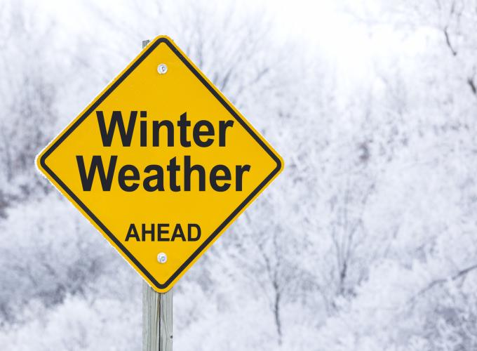 Yellow and black winter weather image with snow filled background