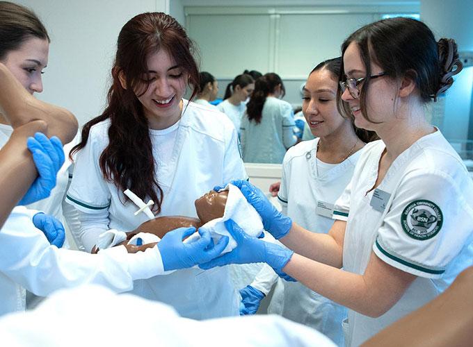 GGC nursing students Simonne Lipan, Jazlyn Sanchez, Allison Valdivia and Naomi Scumpieru Bogde work together as they learn how to clean up a newborn after delivery during the Mama Ann simulation