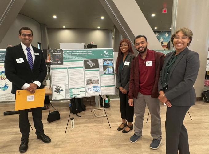Three students and a mentoring professor stand by a poster board containing their research findings.