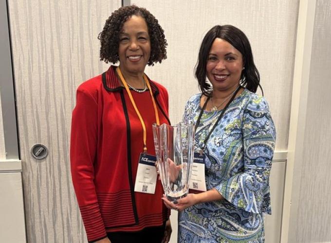 Dr. Jann L.  Joseph, president of Georgia Gwinnett College and chair of the ACE Women’s Network, standing with Crystal Chambers, program chair of the North Carolina ACE Network., who is holding a vase award