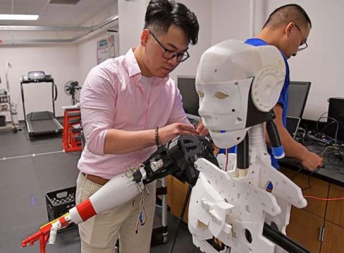 Two GGC students conducting a robotics demenstration in a lab
